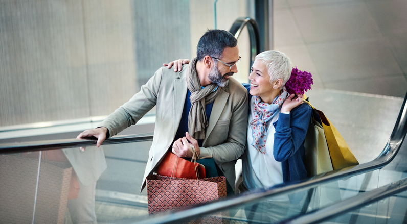 Generation X customers shopping, using an escalator