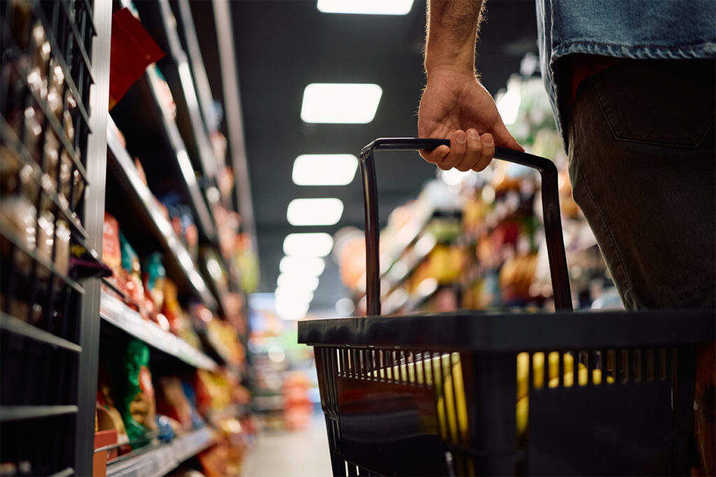 Retail crime shopper holding basket in shop